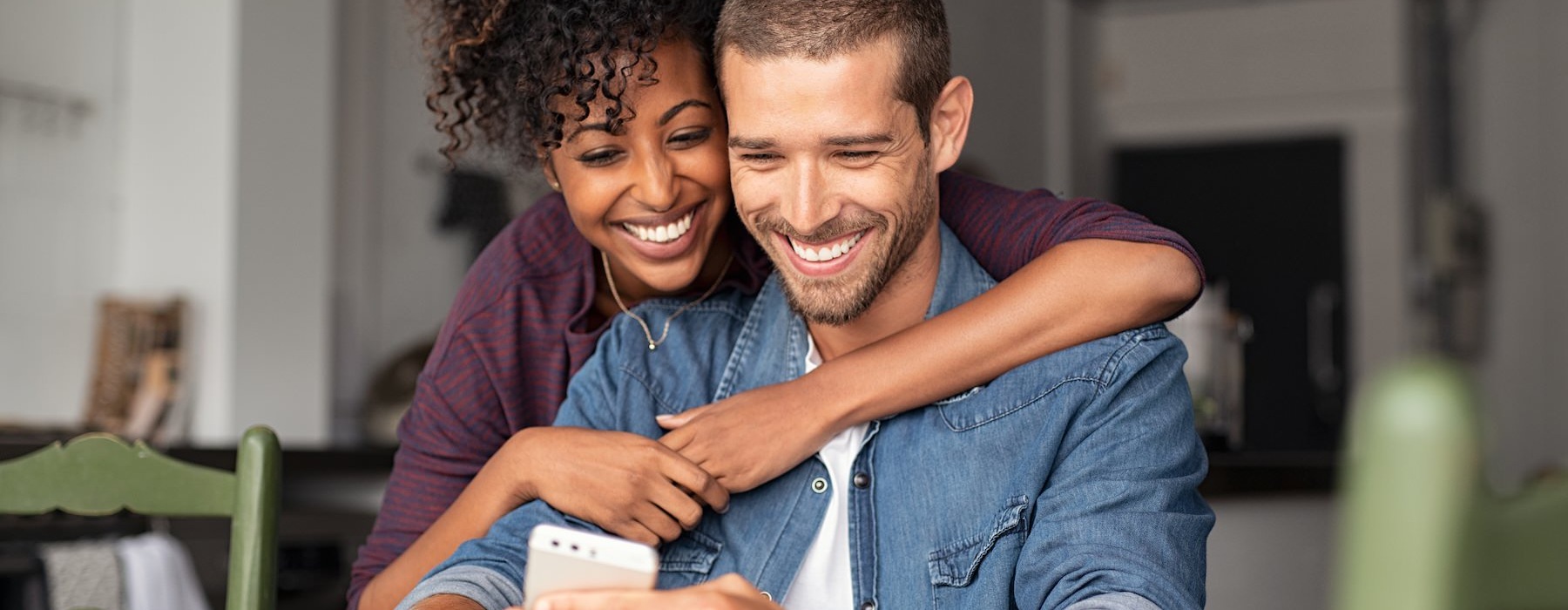 a man and a woman looking at a phone